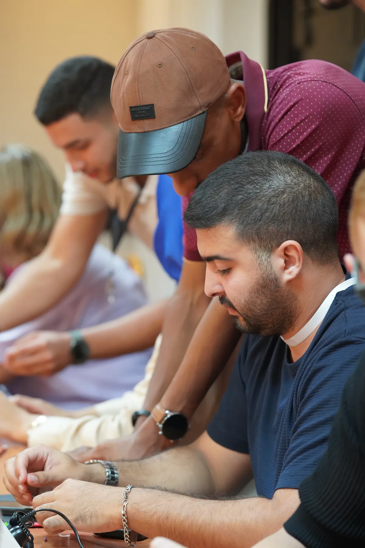 Participants côte à côte à leur poste, un encadrant en appui, Summer Bootcamp 2025
